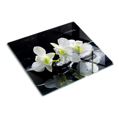 Schneidebrett glas Orchideen auf schwarzem Hintergrund