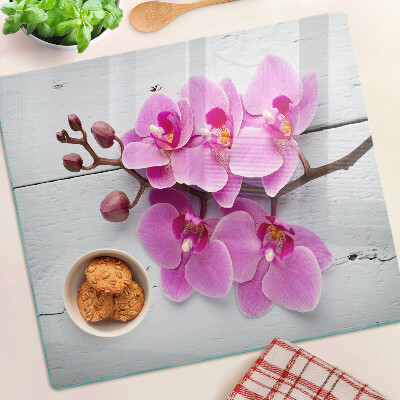 Schneidebrett glas Orchideen auf weißem Hintergrund