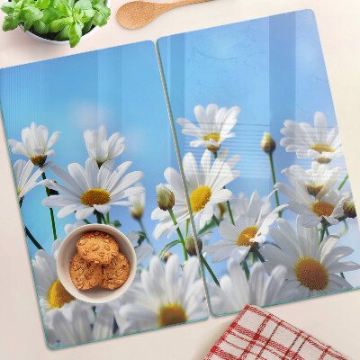 Glasschneidebrett Gänseblümchen auf blauem Hintergrund