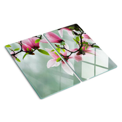 Glasschneidebrett Magnolienblüten vor einem grünen Hintergrund
