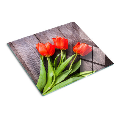 Schneidebrett glas Tulpen auf einem hölzernen Hintergrund