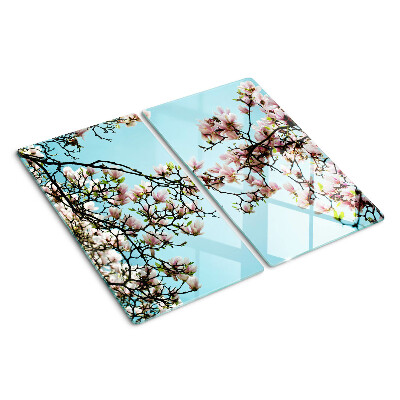 Glasschneidebrett Magnolienblüten auf blauem Hintergrund