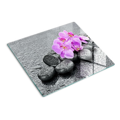 Schneidebrett glas Blumen und Steine gegen das Wasser