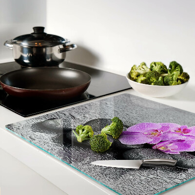 Schneidebrett glas Blumen und Steine gegen das Wasser