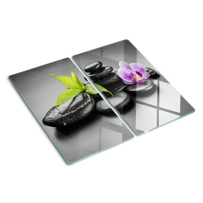 Glasschneidebrett Steine und Orchideen im Hintergrund