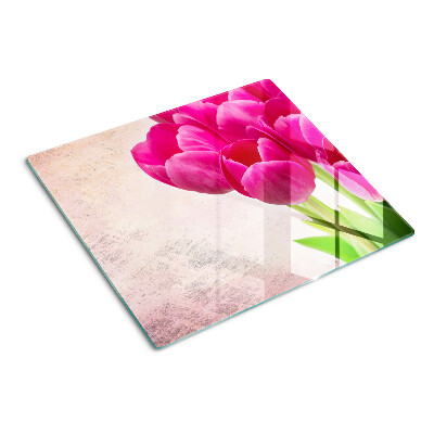 Glasschneidebrett Tulpenblüten auf rosa Hintergrund