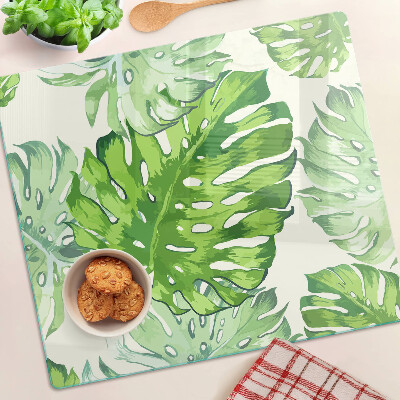 Glasschneidebrett Monstera-Blätter auf hellem Hintergrund