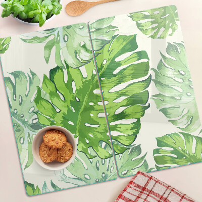 Glasschneidebrett Monstera-Blätter auf hellem Hintergrund