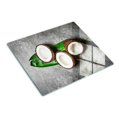 Glasschneidebrett Kokosnuss auf konkretem Hintergrund
