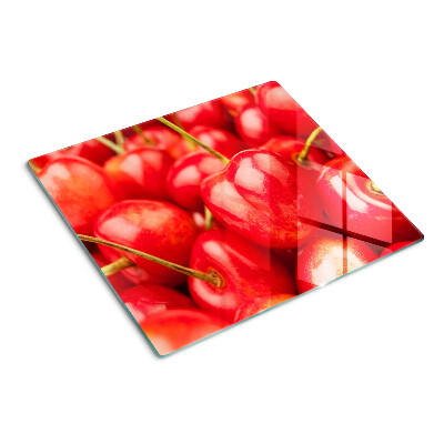 Glasschneidebrett Kirschen auf rotem Hintergrund