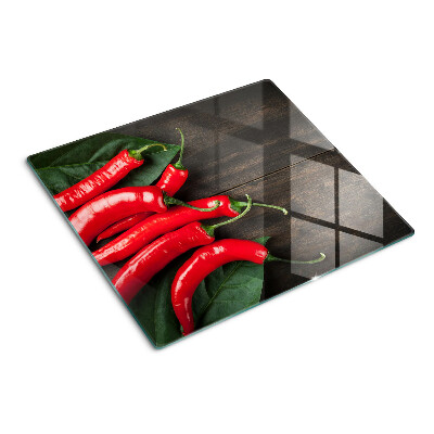 Glasschneidebrett Chilischoten auf einem hölzernen Hintergrund