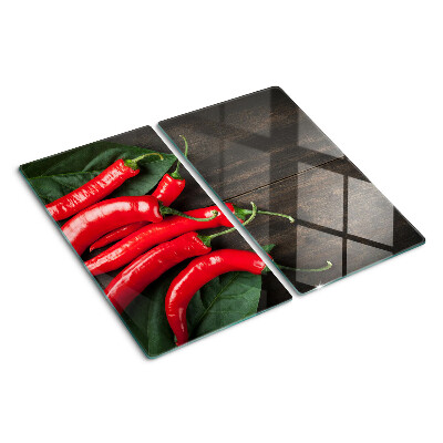 Glasschneidebrett Chilischoten auf einem hölzernen Hintergrund