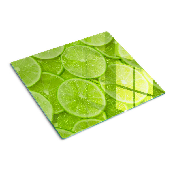 Schneidebrett glas Limettenscheiben auf grünem Hintergrund