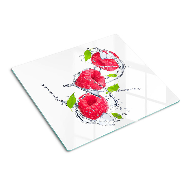 Schneidebrett glas Himbeeren im Wasser mit Blättern