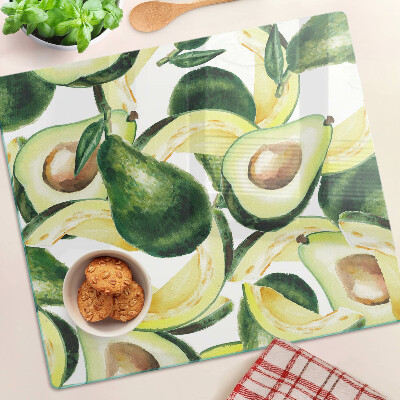 Glasschneidebrett Avocado auf einem Hintergrund aus Blättern