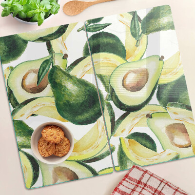 Glasschneidebrett Avocado auf einem Hintergrund aus Blättern
