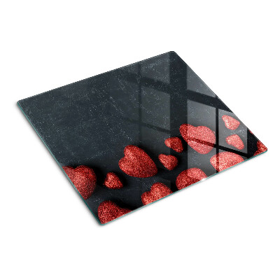 Glasschneidebrett Rote Herzen auf dunklem Hintergrund