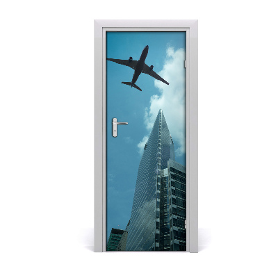 Selbstklebendes wandbild an der wand Flugzeug über die stadt