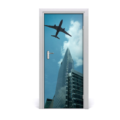 Selbstklebendes wandbild an der wand Flugzeug über die stadt