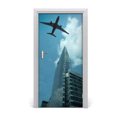 Selbstklebendes wandbild an der wand Flugzeug über die stadt