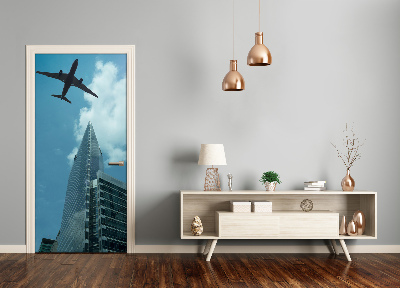 Selbstklebendes wandbild an der wand Flugzeug über die stadt