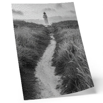 Wandposter Ein Leuchtturm vor dem Hintergrund von hohem Gras