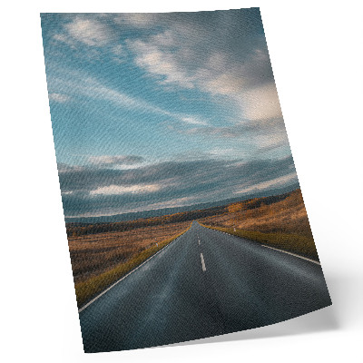 Kunstdruck leinwand Eine Straße durch die Herbstebene unter blauem Himmel