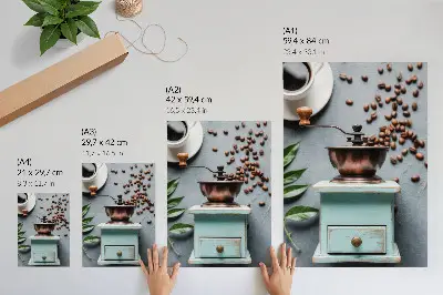 Wandposter alte türkisfarbene Kaffeemühle mit Kaffeebohnen und grünen Blättern