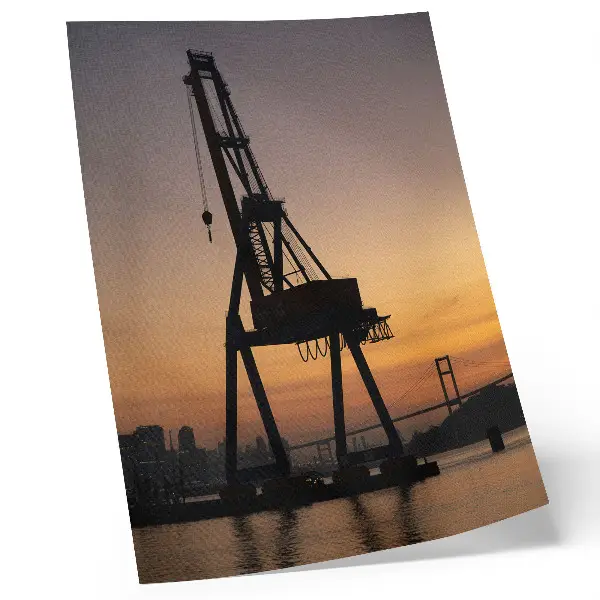 Poster Silhouette eines Industriekrans bei Sonnenuntergang an einer Brücke