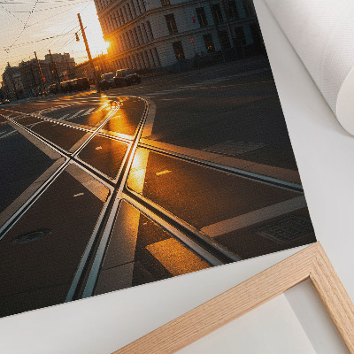 Wandposter Die untergehende Sonne über der Stadt mit ihrer Architektur