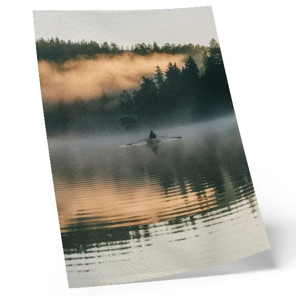 Wandposter Boot im Nebel auf dem See mit grünen Bäumen und Wasserspiegelungen