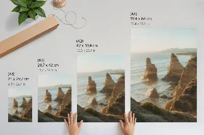 Wandposter Felsenklippen bei Sonnenuntergang am Meer