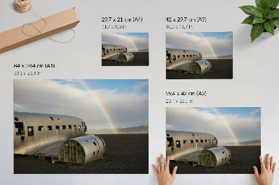 Poster Ein Flugzeugwrack aus Metall vor dem Hintergrund eines Regenbogens.