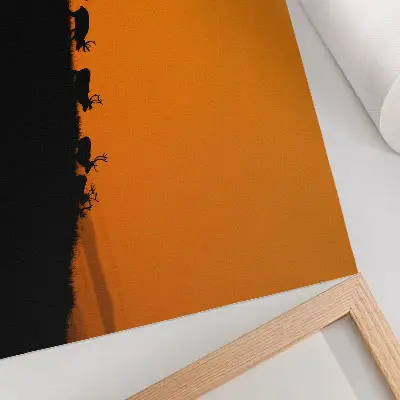 Kunstdruck Poster mit Silhouetten von Hirschen auf einem Hügel vor orangefarbenem Hintergrund