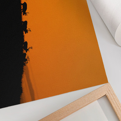 Kunstdruck poster Silhouetten von Hirschen auf einem Hügel vor orangefarbenem Hintergrund