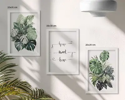 Fotowand mit Aquarell Monstera Blättern und dem Spruch Zuhause ist es am schönsten