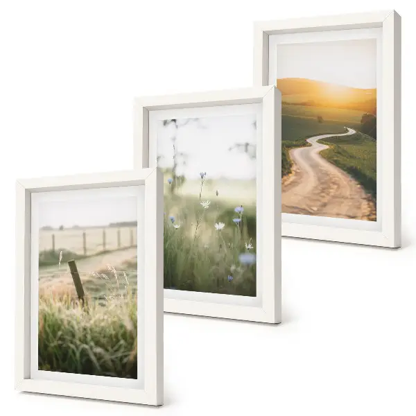 Bilderwand mit Landschaftsmotiv von Wiese, Straße und Sonnenuntergang