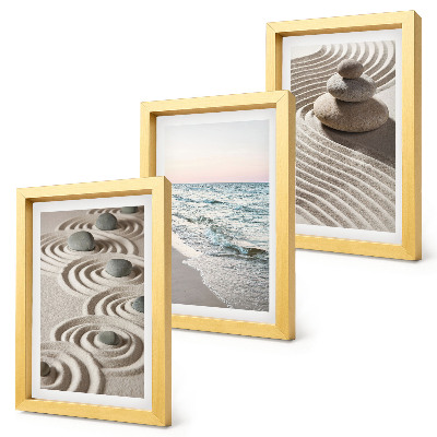 Fotowand Ruhige Wellen aus Sand und Wasser mit Steinen am Strand